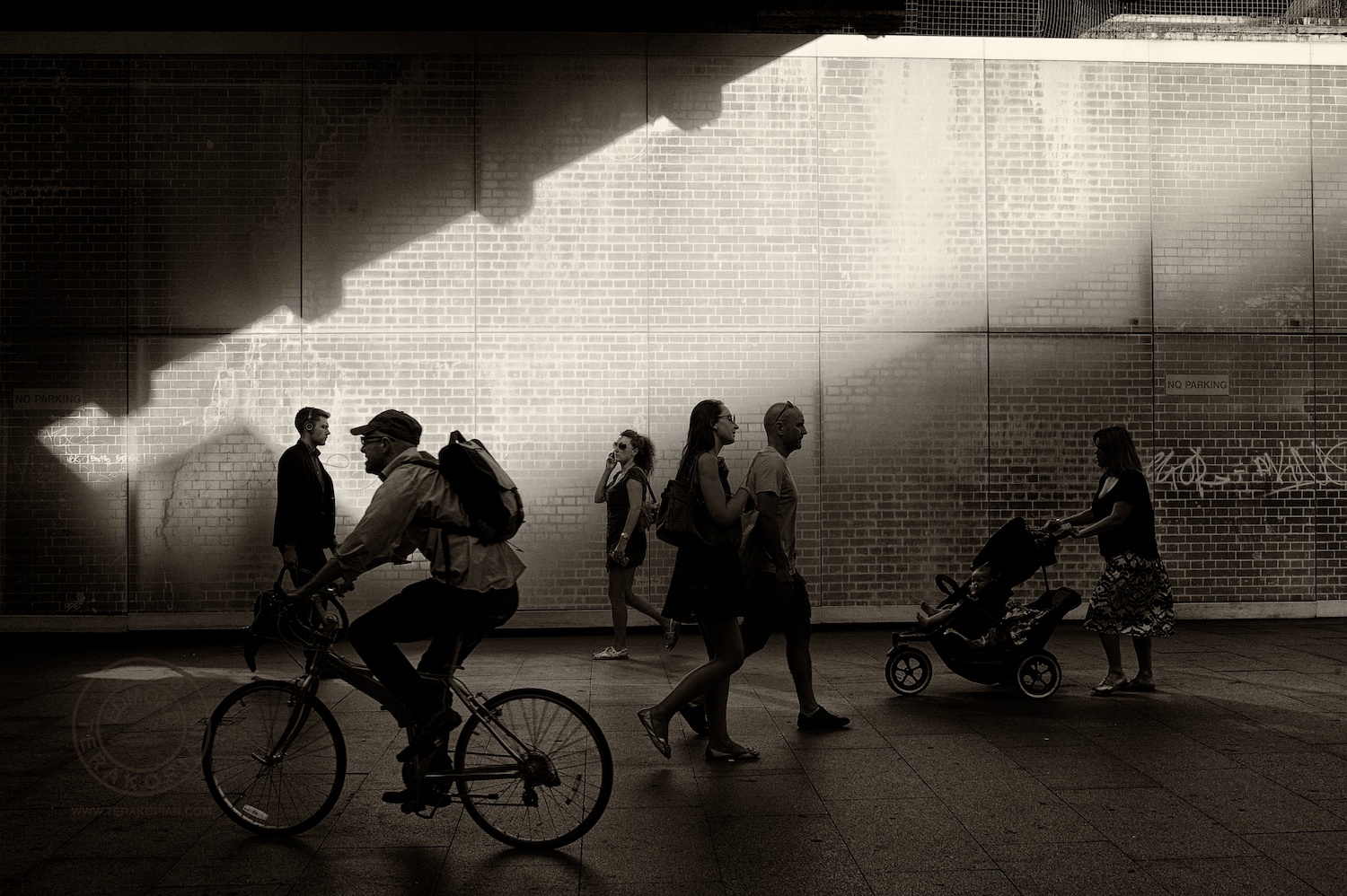 London's South Bank.  Pedestrians walk past a bridge.   July 15, 2013. Photo: ©Edmond Terakopian / 2013
