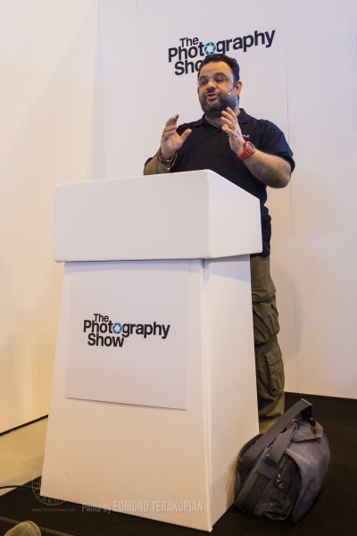 "Essentials In Documentary Film Making" talk by Edmond Terakopian at the Filmmaker Theatre on behalf of Snapper Stuff. My laptop bag, a blue Think Tank Photo Retrospective 13L can be seen by the podium. The Photography Show, NEC, Birmingham. March 23, 2015. Photo: Freia Turland